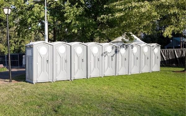 Row of event portable toilet units set up outdoors