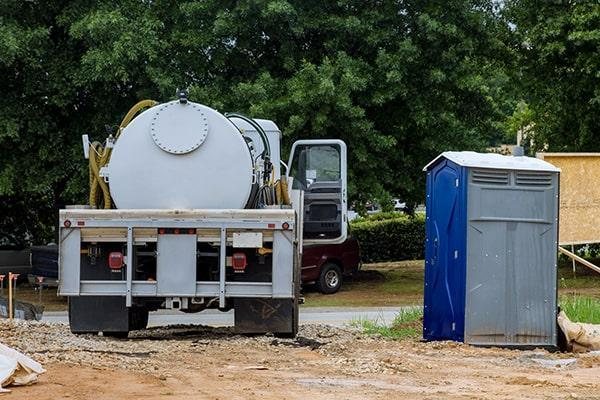 Row of standard portable toilets ready for rental delivery
